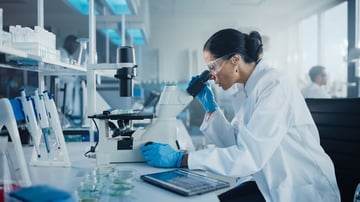 2141_Scientist looking under microscope