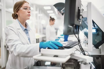 card-3210_Laboratory technicians conduct a series of tests on a chemical analyzer