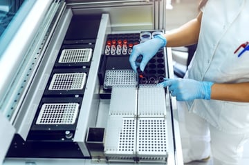 card-3285_Cropped picture of lab assistant putting flasks with urine samples into machine.