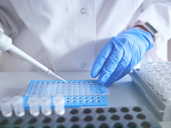 3233_Laboratory scientist working at lab with micropipette, and 96 well plate